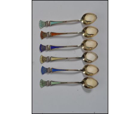 A set of six Norwegian sterling silver and enamel tea spoons by J.Tostrup each spoon having a different coloured enamel panel