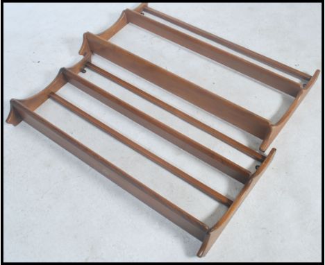A pair of 20th century Golden Dawn two tier Ercol plate racks Each with applied blue Ercol sticker to the rear.  
