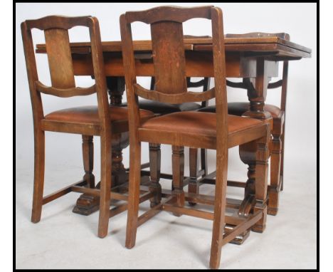 A 1940's / 1950's post war Art Deco oak dining room suite by Ercol. The set comprising draw leaf refectory dining table toget