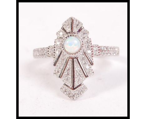 A 1930's Art Deco silver and opal ladies dress ring having odeon style design. Complete in the presentation case. Total weigh