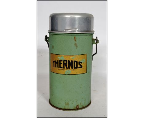 An original vintage metal cased 'Thermos' flask in green with notation to front.