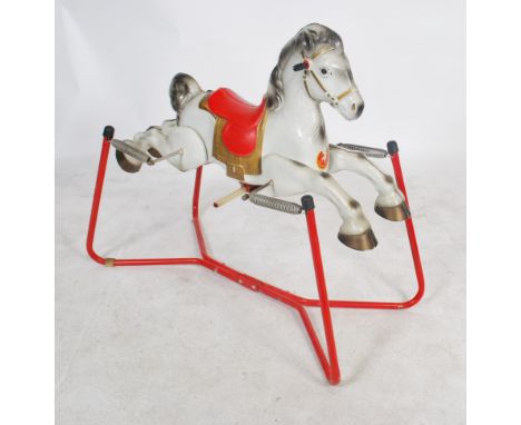 A vintage mid century tin plate child's Prairie King rocking horse by Mobo with red  seat, suspended by four coiled springs a
