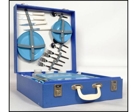 A vintage 20th century retro picnic hamper by Brexton to include flasks, sandwich boxes, plates, cups etc. held within origin