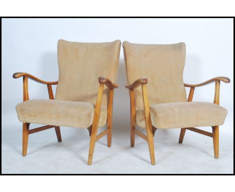 A pair of vintage mid 20th century his and hers open framed elm armchairs, having a button back chintzy fabric raised on tape