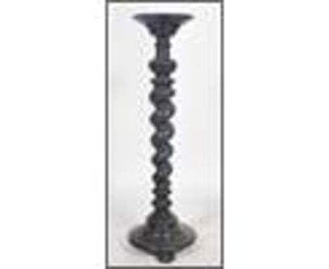 An early 20th century Edwardian tall ebonised tourchere / plant stand of baley twist form having plinth top and base100x30cms