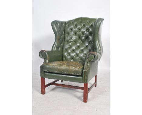 A superb 20th century, Edwardian / 1920's style full grain leather Chesterfield armchair. Raised on mahogany square tapering 