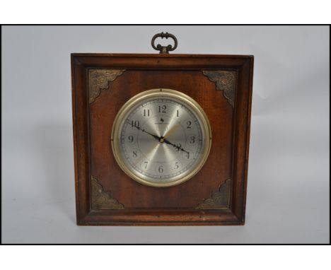 A 20th century square wooden cased mantel clock with circular dial with faceted hands. Notation for Milford Guild. Measures 3
