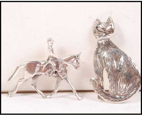 Two 20th century silver brooches, one in the form of a horse and rider ( hunting interest ) together with another in the form