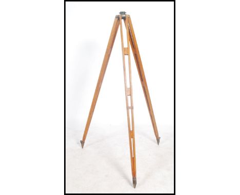 A good early 20th century wooden theodolite tripod stand being ideal for upcycling to a theatre light stand etc