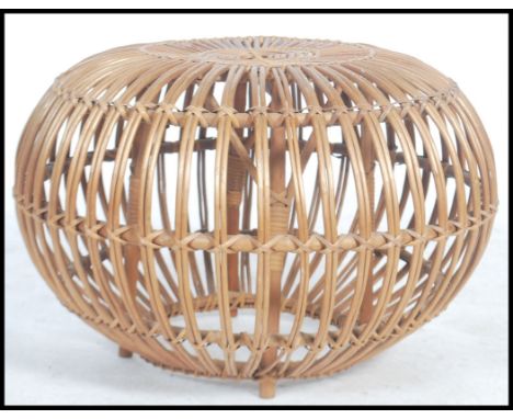 A retro 20th century wicker stool / pouffe entirely constructed from wicker of orb structure Measures 41cms high by 65cms.