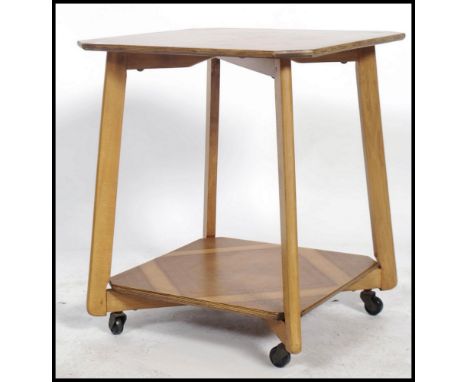 A 1930's Art Deco walnut qtr veneer lamp table having angular supports with twin tiers being qtr veneer