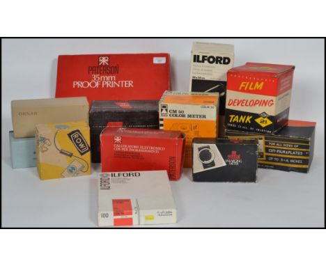 A collection of vintage camera equipment to include a Ilford Dy-Drum processing tank, Nebro developing tank, Cds enlarger com