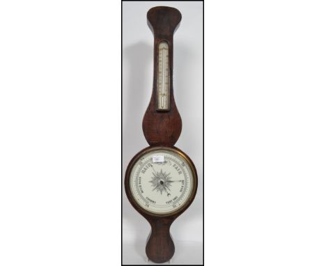 An early 20th century banjo barometer having a milk glass dial of circular form with thermometer to the neck