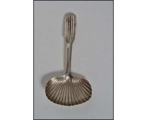 A Georgian silver caddy spoon with shell shaped bowl. Unmarked weighs 8.4 grams.