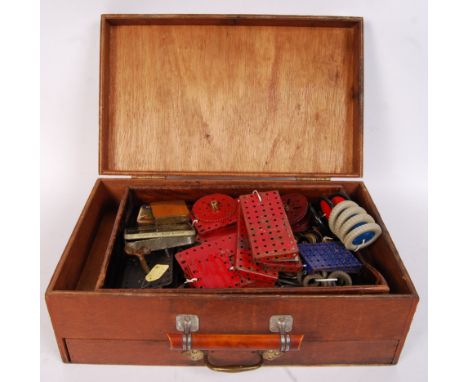 An original vintage Mecanno kit to include; Red & blue straights, tine of nuts & bolts, clockwork motor with key, wheels, cog