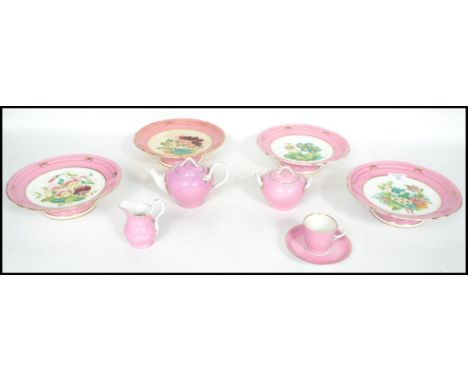 A group of four 19th century ceramic tazza's having hand painted floral decoration, the tazzas of pink ground with a central 
