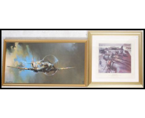 A framed picture print of a Super Marine Spitfire in flight by Barrie together with framed and glazed picture of a Wellington