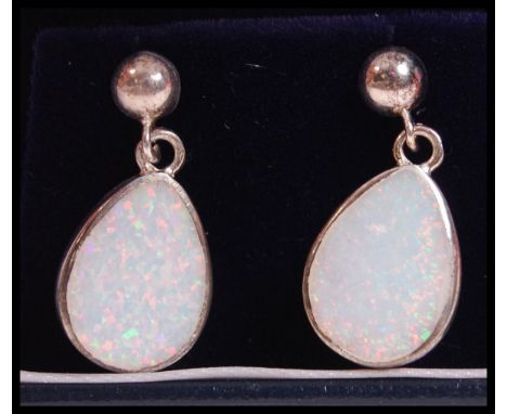 A pair of silver and opal ladies earrings, each of pear shape and complete in the presentation case.