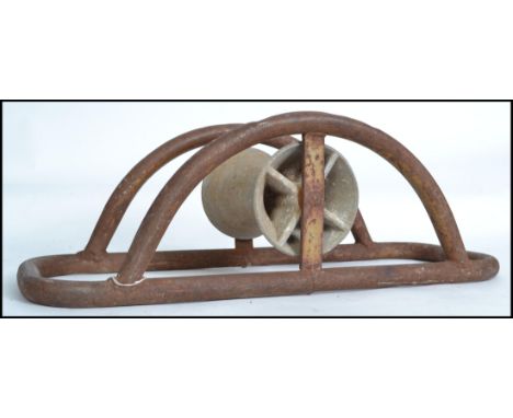 An Industrial mid century tubular wrought metal cable bender. Of arched form with central spinning wheel, the item used for b