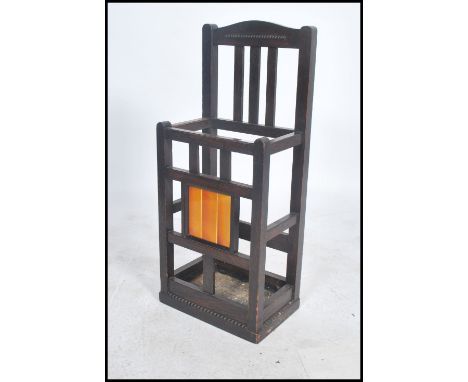 A stunning early 20th century Arts and Crafts two sectional tile back oak stick stand retaining original liners / trays.