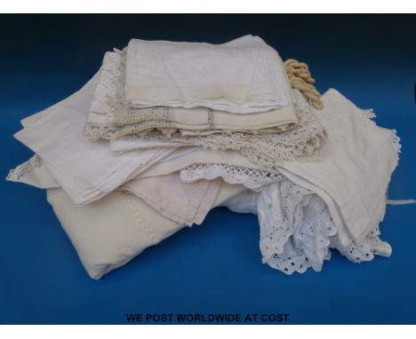 A ribboned bed cover, four Victorian tiebacks, linen, damask, tablecloths, etc