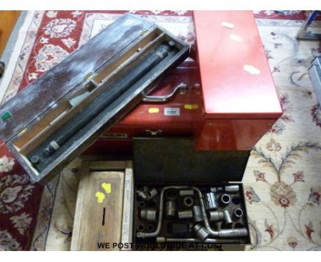 A red Stackon toolbox with tools, drill bits, rolling rule etc 