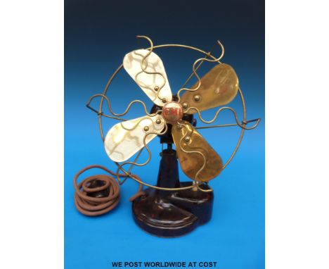 A vintage EMI brass and bakelite desk fan with attachment to run from a light bulb socket