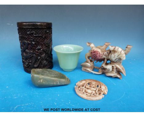 A Chinese carved brush pot together with a hardstone dragon and pendant, a Jadeite boulder with carved seal to one side and a