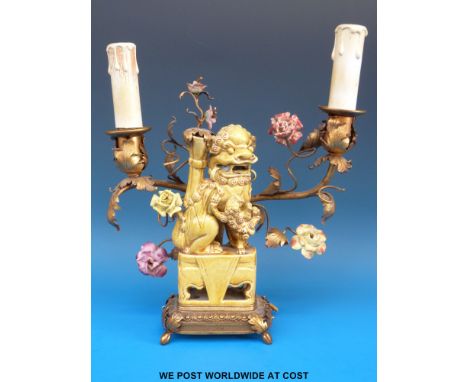 An early electric twin-branched candelabra table lamp in the form of a Fu Dog with metal label to base "BDER France 237 Rue S