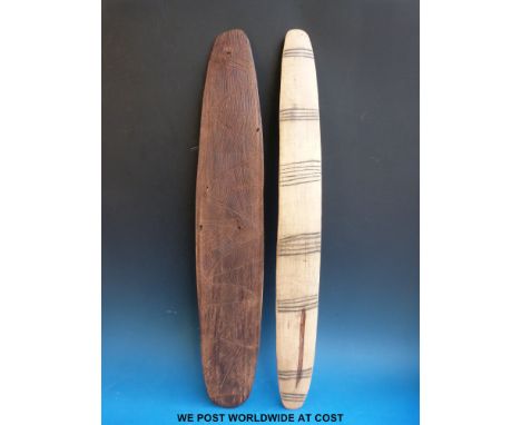 A carved Aboriginal wooden shield with geometric line carved decoration together with another light wood example, items were 