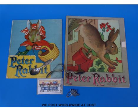 Two Charles Graham & Co Peter Rabbit books, three Peter Rabbit child's spoons, Peter Rabbit safety pins and a hat badge