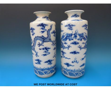 A pair of 19thC Chinese blue and white cylindrical vases with inverted rim decoration of dragon chasing flaming pearl. Four c