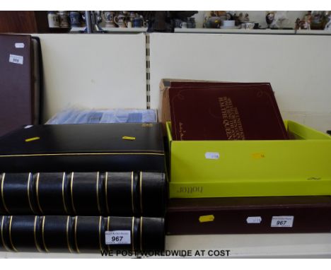 Two albums of greetings postcards together with various hold up to the light examples, card wallets etc