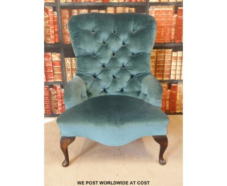 A button-back nursing chair raised on cabriole front legs