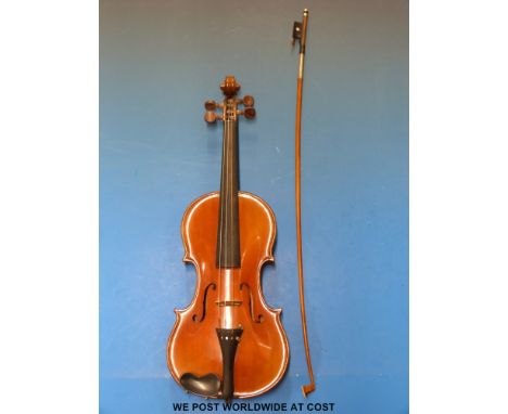 A cased violin with Stradivarius label