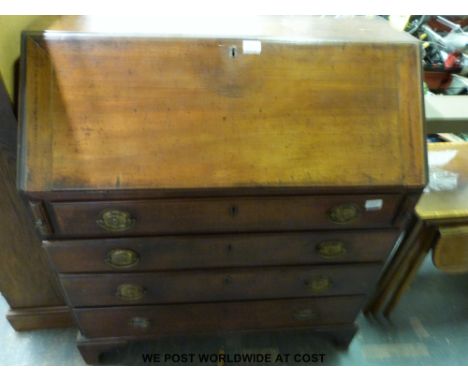 A Georgian mahogany bureau, the fall flap opening to reveal drawers pigeon holes and central cupboard, with four graduated dr