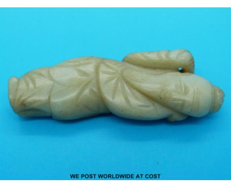 A jade figure of a sage with russet inclusions (8cm long) 