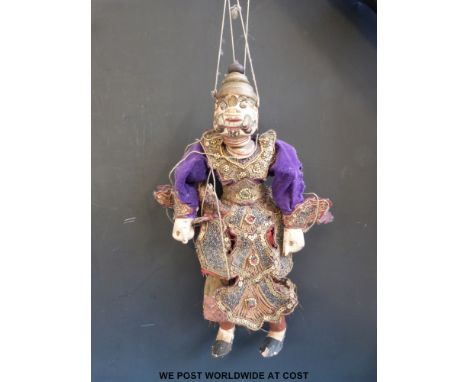 An Indonesian carved wooden puppet in traditional dress (40cm tall)