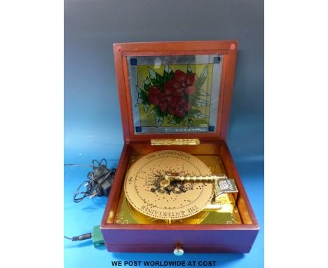 A Thoren electric powered music box playing plastic discs, 20 note comb and extra discs in tray below instrument 