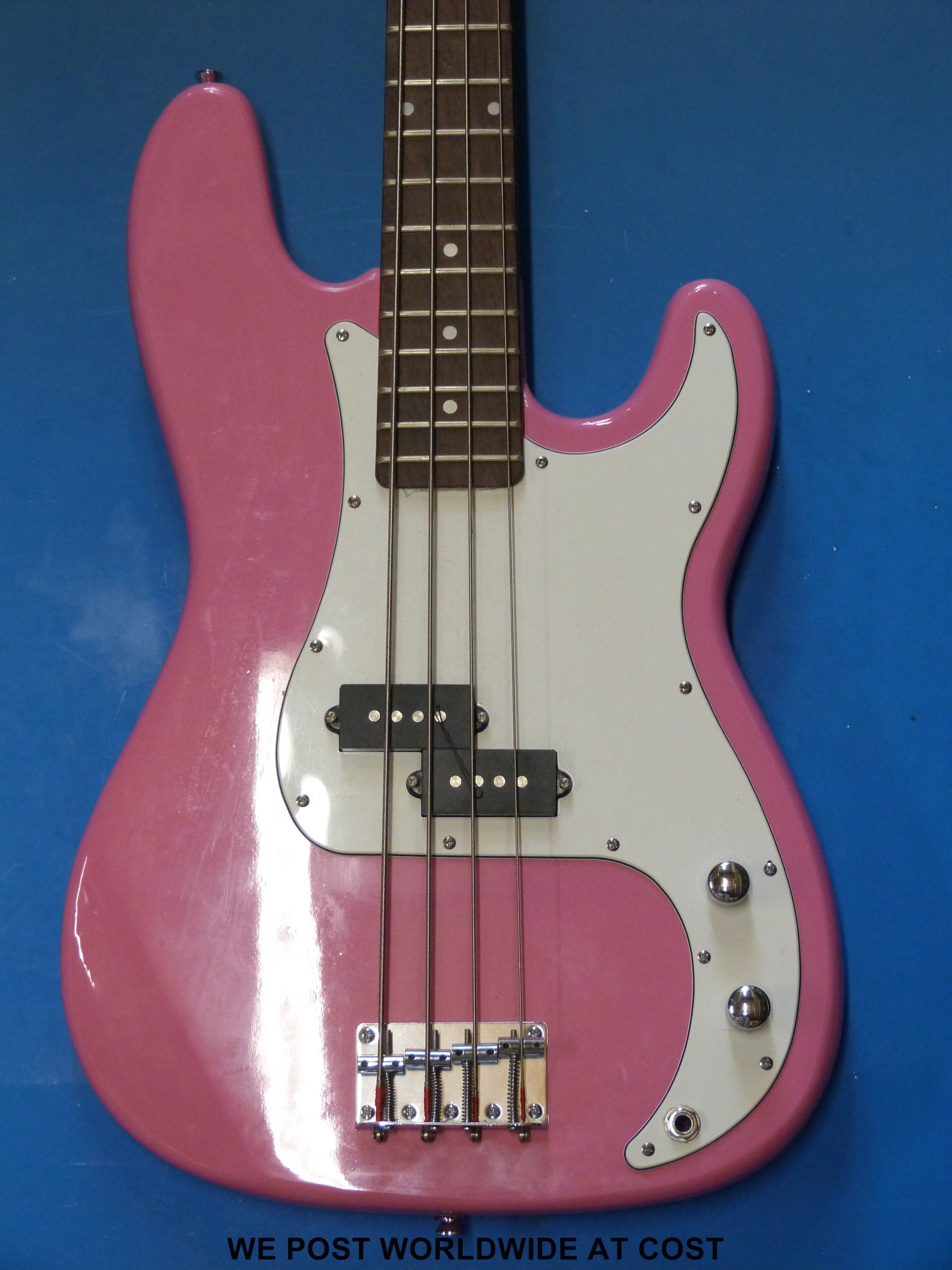 A Swift electric bass guitar in pink finish with case