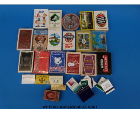A collection of playing cards including advertising and a collection of match boxes and match books 