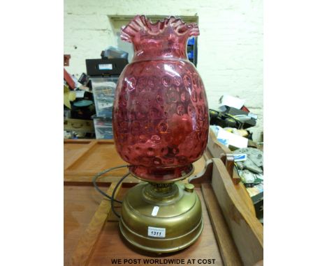 A brass oil lamp converted to electricity with cranberry shade (h51cm)   