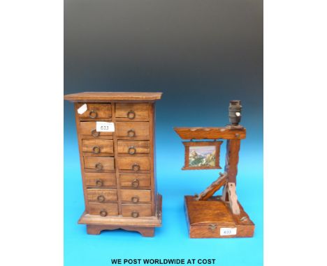 A miniature chest of 14 drawers all with ring handles together with an oak musical lamp with jewellery compartment  