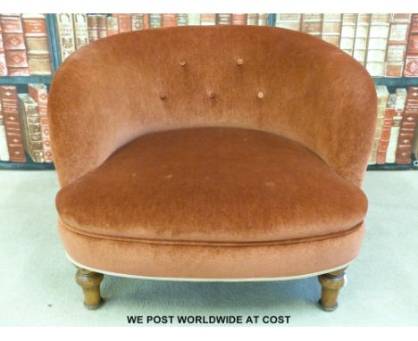 A small button-backed nursing chair raised on turned legs
