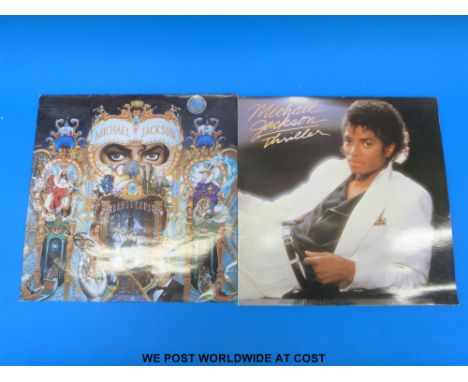 Two LPs by Michael Jackson : “Dangerous” and “Thriller”.  The condition of the vinyl appears to be excellent.
