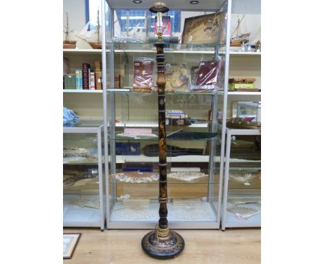 A Chinese lacquer standard lamp with figural decoration raised on a circular base (178cm tall) 