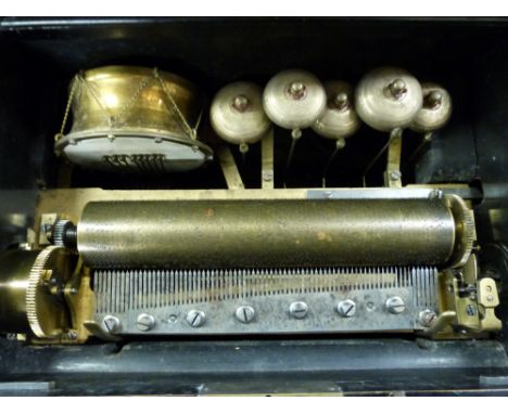 A cylinder musical box playing eight airs on a standard combe with five bells and a eight beater drum. Bells and drum can be 