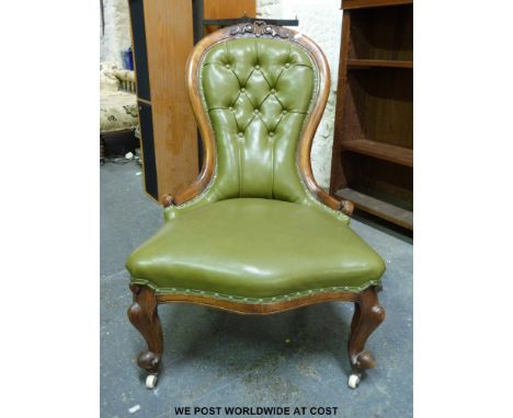A Victorian walnut carved spoon back button upholstered nursing chair with scroll turned ends, serpentine fronted with carved