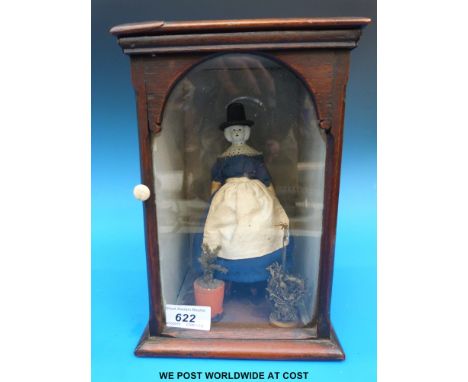 A wooden and ceramic doll in display case, height 25cm