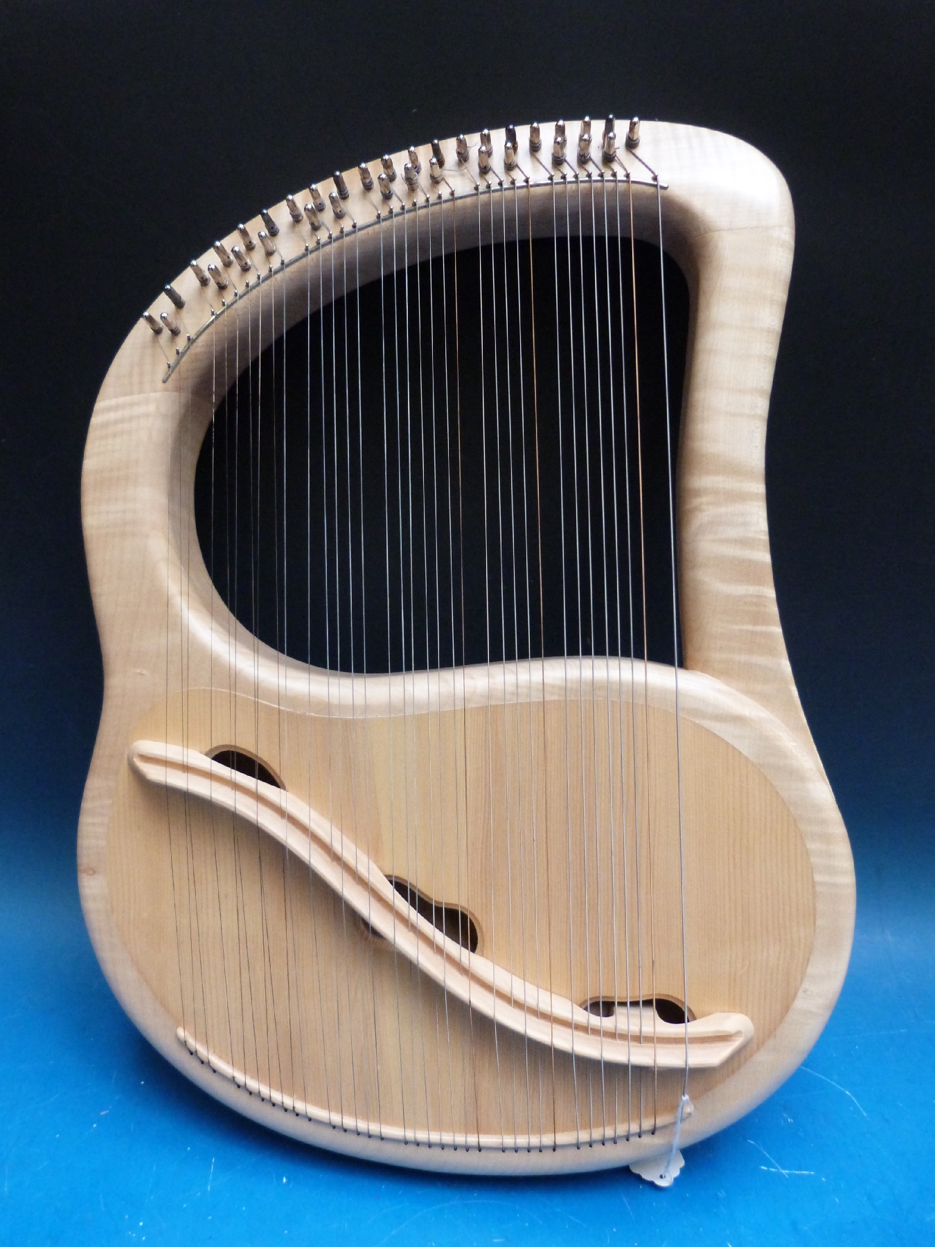 A cased fully chromatic 35 string soprano lyre in sycamore by Sophia